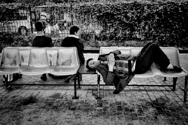 Guy sleeping in train station in Iasi Romania